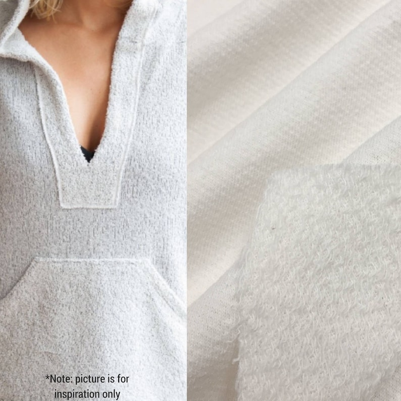 May include: A white hooded sweatshirt with a v-neck and a pocket. The fabric is a soft, textured knit.