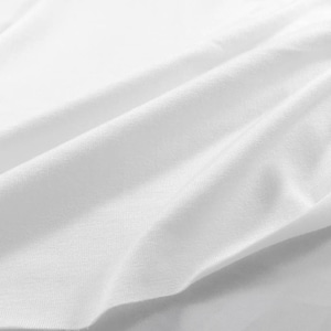 May include: White fabric with a smooth, soft texture. The fabric is folded and draped, creating a gentle wave pattern.