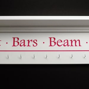 May include: White wooden shelf with a red line and hooks labeled "Vault · Bars · Beam · Floor".