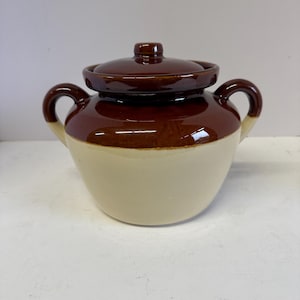 May include: A set of three ceramic mugs with a speckled, matte finish. The mugs are in shades of cream, light gray, and dark gray. Each mug has a simple, minimalist design, perfect for coffee or tea.