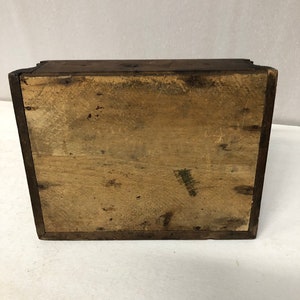 May include: A wooden box with a plain, light brown interior. The box is closed and the lid is not visible.