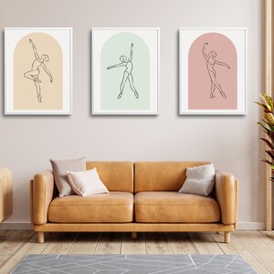 May include: Three framed line drawings of a ballerina in a single-line style. Each drawing is set against a different colored background: peach, light green, and pink.
