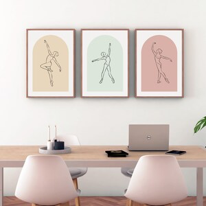 May include: Three framed line drawings of a ballerina in various poses. Each drawing is set against a different colored background: peach, light green, and light pink.
