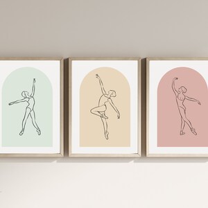 May include: Three framed prints with a line drawing of a ballerina in a variety of poses. Each print has a different colored background: green, yellow, and pink.