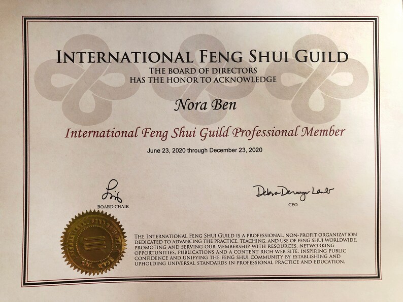 May include: A certificate from the International Feng Shui Guild, acknowledging Nora Ben as a Professional Member. The document features the guild's logo, the Board of Directors' acknowledgment, and the dates June 23, 2020, to December 23, 2020.