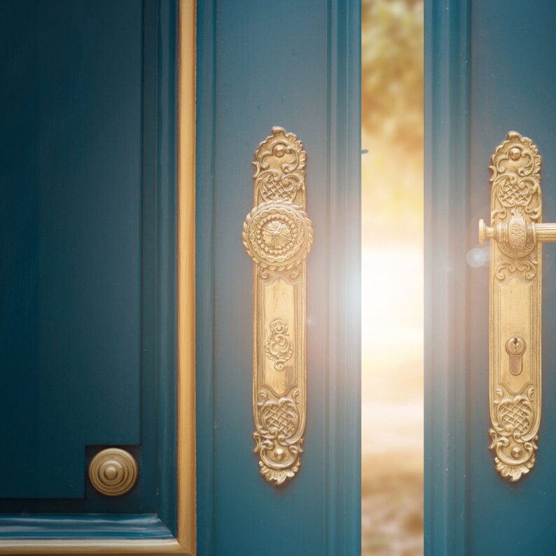 May include: A teal door with gold trim and ornate gold door hardware. The door is slightly ajar, revealing a bright, sunlit space. The hardware includes a long, decorative plate with a round knob and a handle with a keyhole.