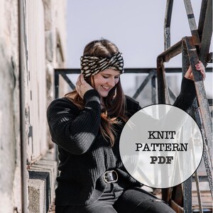 May include: A woman wearing a black sweater, black jeans, and a black and white knit headband. The image includes the text "KNIT PATTERN PDF" in a circular graphic. The woman is sitting on metal stairs.