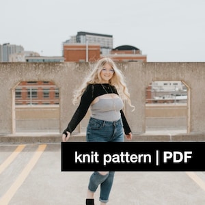 May include: A woman wearing a black knit crop top with long sleeves, a gray tank top, blue jeans, and black shoes. The text "knit pattern | PDF" is visible in the image.