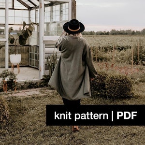 May include: A woman wearing a green knitted cardigan and a black hat walks away from a greenhouse. The text "knit pattern | PDF" is at the bottom of the image.