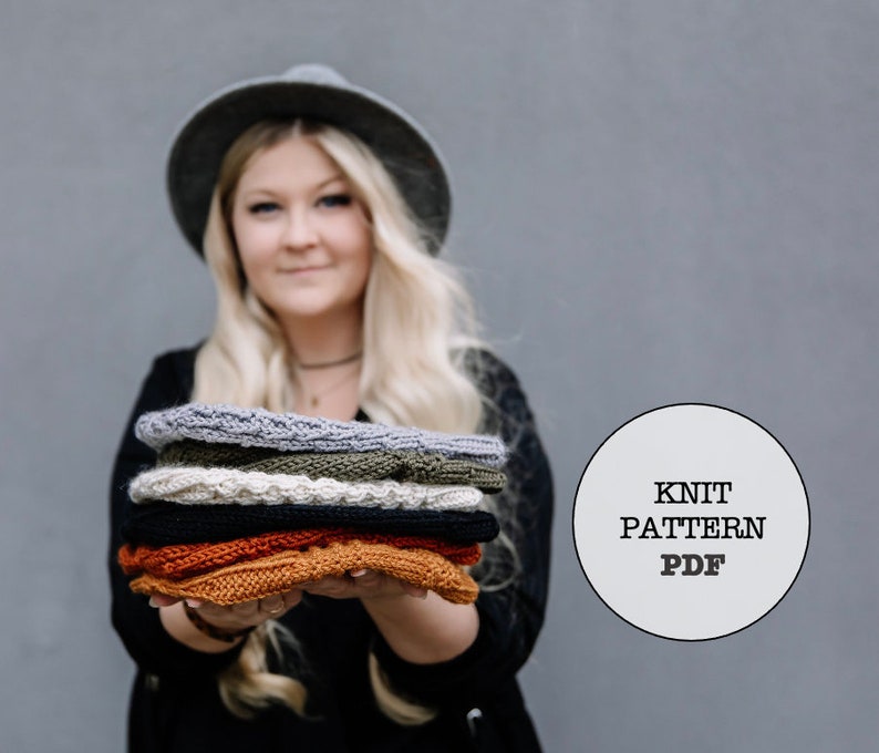 May include: A stack of six knitted headbands in various colours, including grey, green, cream, black, and orange. The headbands are held in front of a grey background. A white circle with the text "KNIT PATTERN PDF" is in the image.