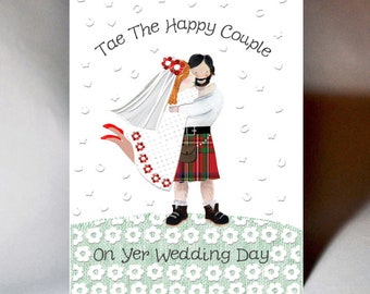 May include: A wedding card with a cartoon illustration of a couple in traditional Scottish attire. The bride is wearing a white dress and veil, and the groom is wearing a kilt. The card says "Tae The Happy Couple On Yer Wedding Day".