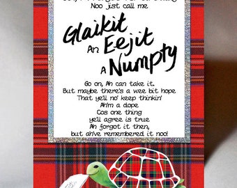 May include: A humorous birthday card with a red and black plaid background. The card features a cartoon turtle holding a letter and a poem that reads "Och, Ah Forgot Yer Birthday Noo jist call me Glaikit An Eejit A Numpty Go on, Ah can take it. But maybe there's a wee bit hope That ye'll no keep thinkin' Ah'm a dope Cos one thing ye'll agree is true Ah forgot it then, but ah've remembered it noo!"