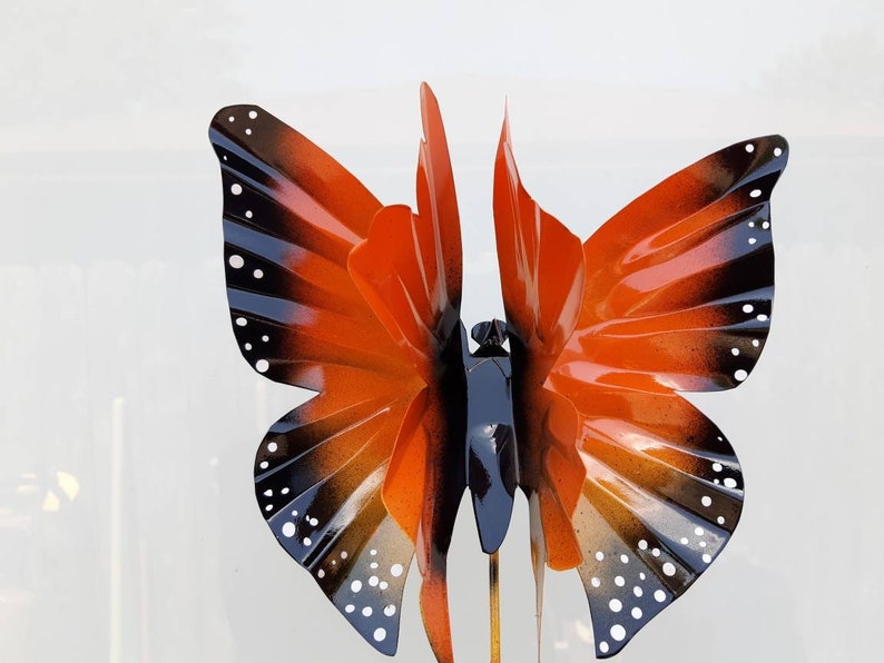 May include: Orange and black metal butterfly garden stake with white polka dots.