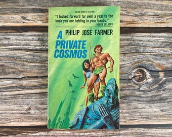 May include: A vintage paperback book cover with a green background featuring a man and woman in a jungle setting. The book title is "A Private Cosmos" by Philip Jose Farmer.