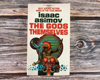 May include: A vintage paperback book cover featuring a colorful illustration of a man with raised arms, a blue-skinned figure, and a multi-colored eye. The book title is "The Gods Themselves" by Isaac Asimov. The cover also includes the text "Best Science Fiction Novel of the Year Award".