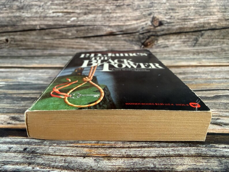 May include: A paperback book titled "Black Tower" by B.D. James. The cover features a noose and key illustration against a dark background. The book's pages are aged, and the spine is visible.