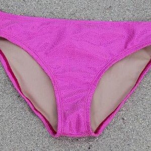 May include: Pink bikini bottom with a textured fabric. The bottom has a nude lining.