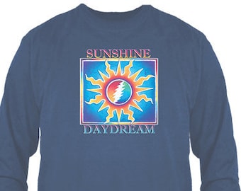 May include: A navy blue long-sleeve t-shirt with a colorful graphic of a sun with a lightning bolt inside. The text "Sunshine Daydream" is printed below the graphic.