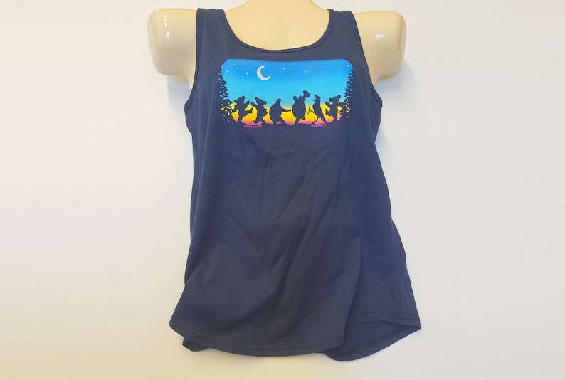 May include: A navy blue tank top with a graphic print of a group of dancing bears in silhouette against a colorful sunset and night sky. The graphic includes a crescent moon and stars.
