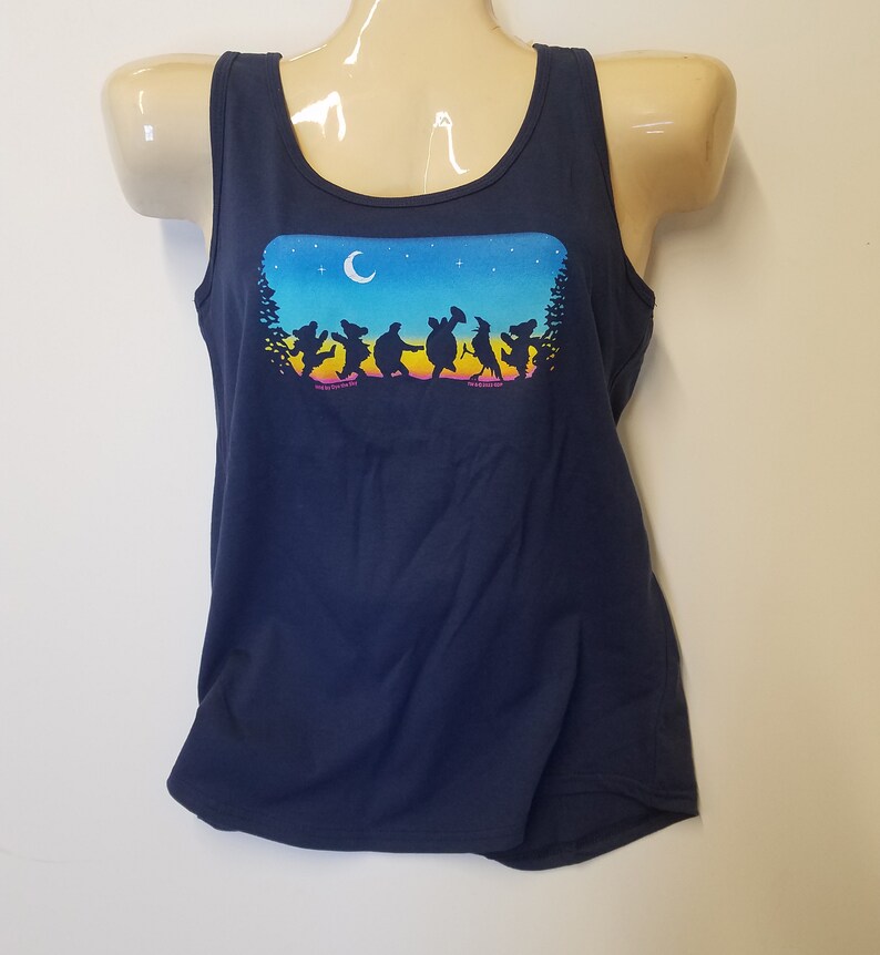 May include: A navy blue tank top with a graphic of a group of dancing bears, a turtle, a bird, and a raccoon under a crescent moon and stars. The graphic is in rainbow colors.
