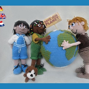May include: Four crocheted dolls, two girls and two boys, stand around a blue and green crocheted globe. The globe has a sign that says "Save Our Planet".