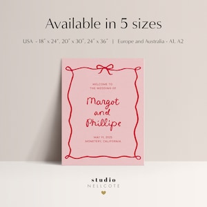 May include: Pink wedding invitation with a red border and a red bow. The text reads "Welcome to the wedding of Margot and Phillipe, May 11, 2025, Monterey, California". The bottom of the invitation reads "studio NELLCOTE".