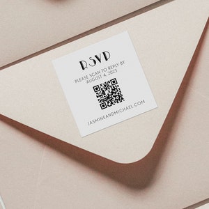 May include: A white RSVP card with a black QR code and the text "RSVP Please scan to reply by August 4, 2023" and "jasmineandmichael.com".