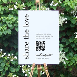 May include: White sign with black text that reads "share the love".  A QR code is included with the text "Please share your photos with us. Simply scan with your smartphone and upload."  The sign also includes the text "samantha and roberto" and "AUGUST 23, 2023".