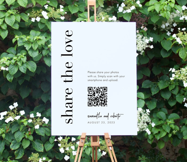 May include: White sign with black text that reads "share the love".  A QR code is included with the text "Please share your photos with us. Simply scan with your smartphone and upload."  The sign also includes the text "samantha and roberto" and "AUGUST 23, 2023".
