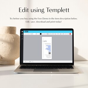 May include: A laptop screen displaying a digital template for a printable "I Spy" game. The template is designed in a minimalist style with black text on a white background. The text "I SPY" is at the top of the template, followed by a list of items to find. The template also includes a QR code.