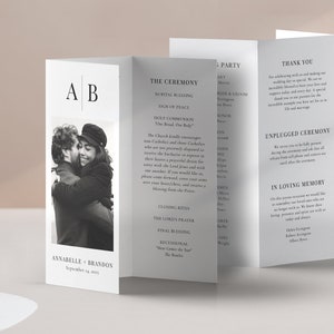 May include: A wedding program with a black and white photo of a couple embracing. The program includes the ceremony details, a thank you note, and a section for in loving memory. The program is printed on white paper with black text.