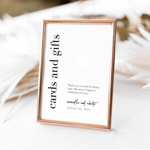 May include: A framed sign with a rose gold border. The sign reads "cards and gifts" in black text. Below, a message of thanks is written, followed by names and the date August 23, 2023.