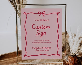 Pode incluir: Um sinal rosa imprimível com uma borda vermelha e um laço vermelho no topo. O sinal diz "100% Editable Custom Sign" e "Use this template to make custom signs to suit your event." O sinal também inclui o texto "Margot and Phillipe" e "May 10-12, 2025".