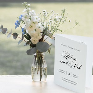 May include: A white wedding program with black text announcing the wedding of Helena and Nich. The program states the wedding will take place on Saturday, November 8th, 2020 at St. James Cathedral in Chicago, Illinois.