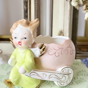 Vintage Napco boy angel pulling an Easter egg cart planter.