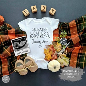 May include: A white onesie with the text "Sweater Weather & Baby Kicks Coming Soon" and a heart. A black and white ultrasound image, a pair of brown baby shoes, and autumn-themed decorations are arranged around the onesie.
