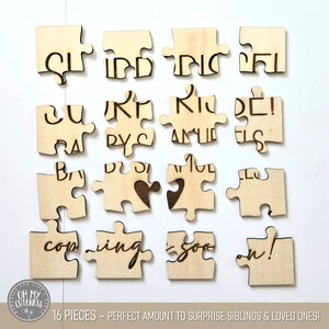 May include: A wooden puzzle with 16 pieces that reads "Our little bundle of joy is coming soon!" The puzzle pieces are in the shape of jigsaw pieces and are arranged in a grid pattern.