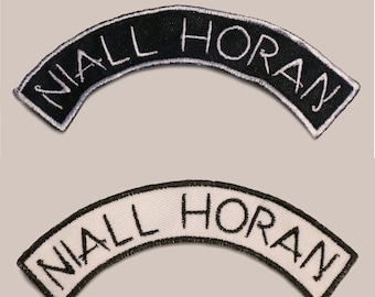May include: Two embroidered patches, one black with white stitching and one white with black stitching, both with the text "NIALL HORAN" in a curved arc.