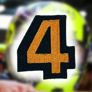 May include: A black and orange embroidered patch with the number "4" in the center.