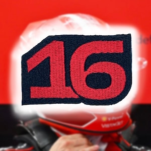 May include: A red and black embroidered patch with the number 16 on it.