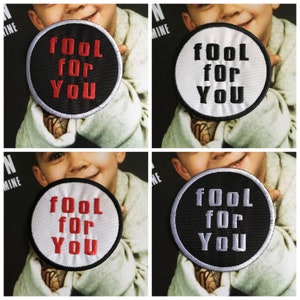 May include: Four embroidered iron-on patches with white, black, and red stitching. The patches are round and feature the text "fool for you" in all caps.