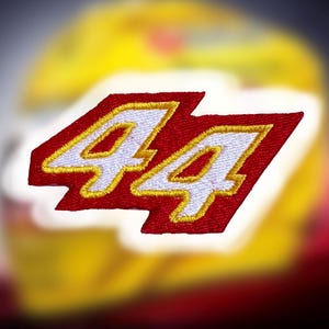 May include: Red and white embroidered patch with the number 44 in white with a yellow outline.