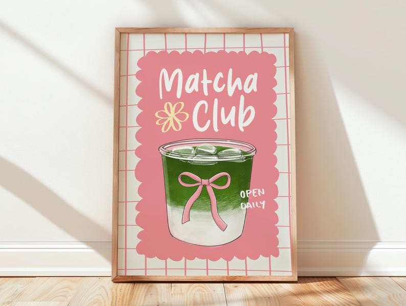 May include: A framed print featuring a matcha drink illustration. The artwork has a pink background with the words "Matcha Club" and "Open Daily." The matcha drink is green with ice cubes and a pink bow.