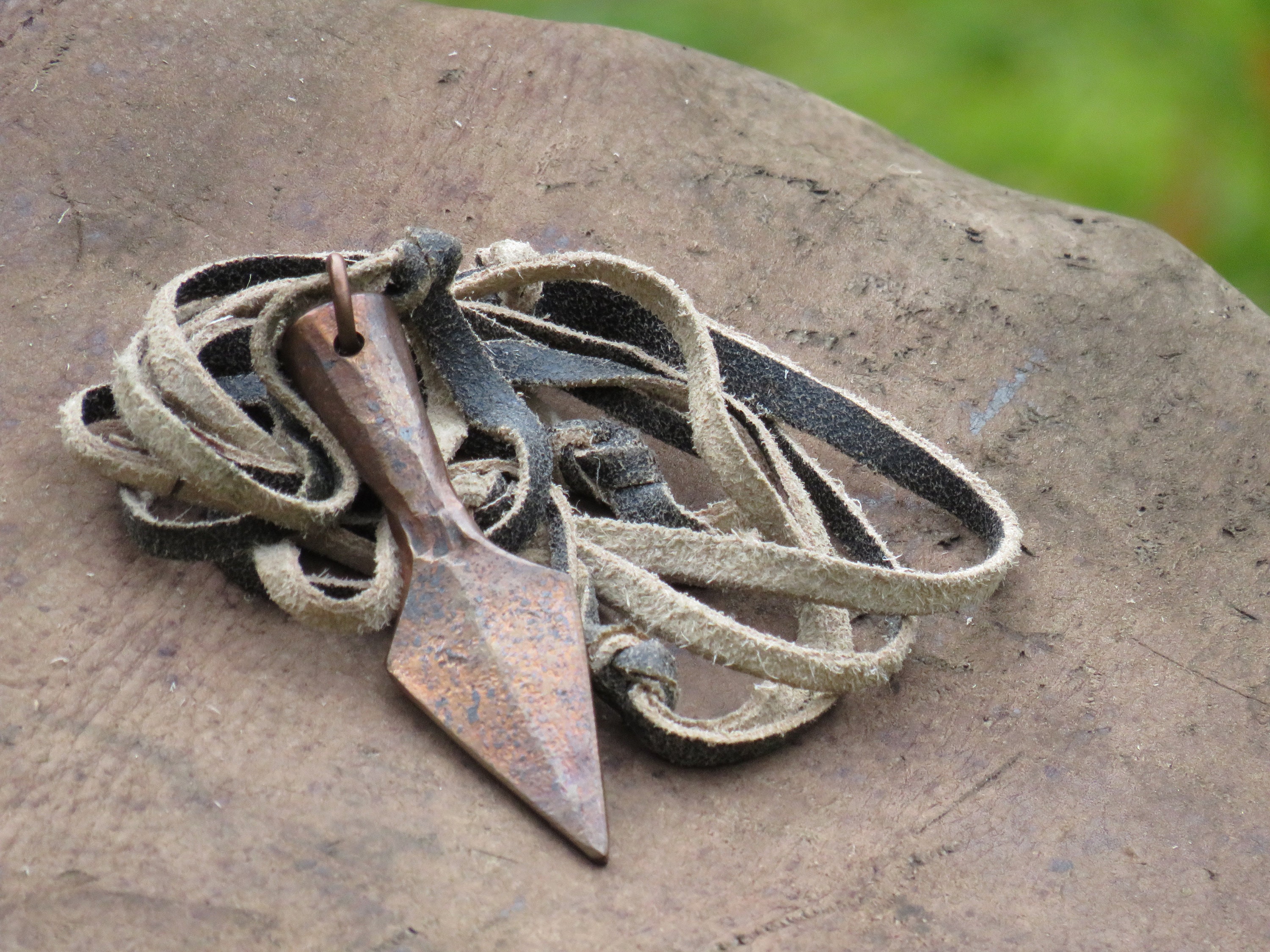 Copper arrow pendant.