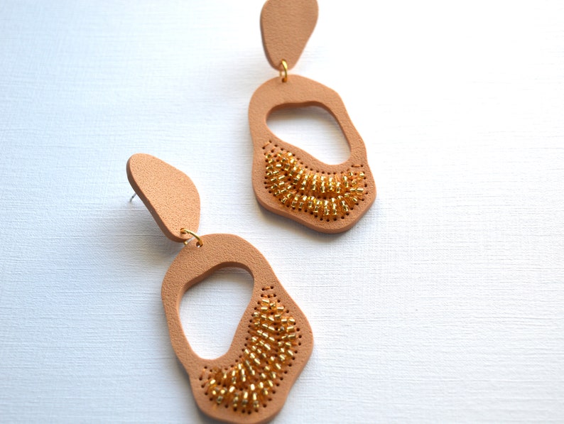 Sparkly statement earrings in organic shapes Handcrafted large earrings embroidered in beads Gold