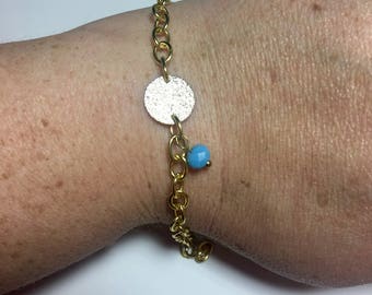 Silver tone textured disc w/gold tone chain and blue bead bracelet