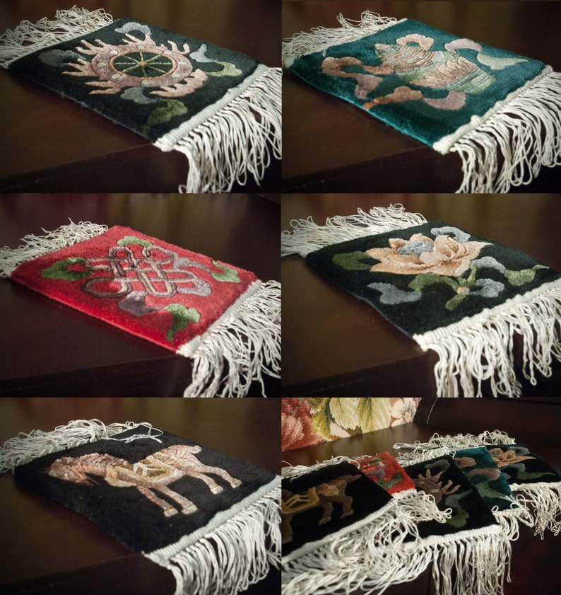 May include: Set of six colorful Tibetan prayer rugs with intricate designs and fringed edges. The rugs feature traditional symbols and motifs, including a wheel, a lotus flower, and a knot.