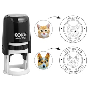 May include: A black and white self-inking stamp with the text "COLOP printer R 30". The image shows a cat and a dog, with the text "MR.LUKE APPROVED" and "TEXT ON TOP TEXT ON BOTTOM" around the images.