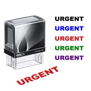 May include: A black and clear self-inking stamp with the word "URGENT" in various colors. The stamp has a black top with a white wave design and the brand name "COLOR". The stamp is labeled "Printer 20".
