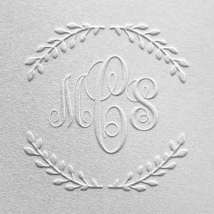 May include: White embossed monogram with the initials "M.P.S." surrounded by a wreath of leaves.